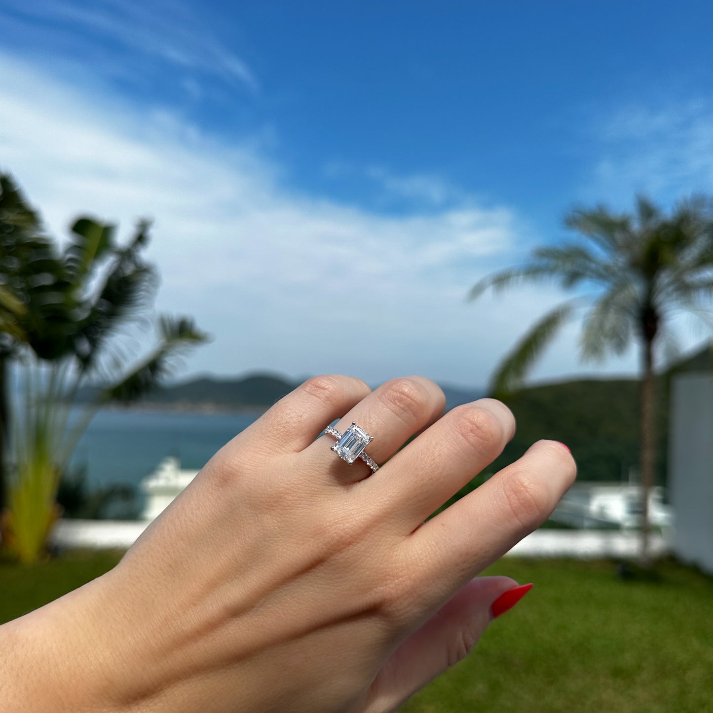 3 carat emerald cut diamond engagement ring with diamond pave on the band. Thin ring makes the diamond stand out. By Valentina Fine Jewellery Hong Kong USA. Free international shipping on all orders. 3 carat emerald cut diamond on hand HK