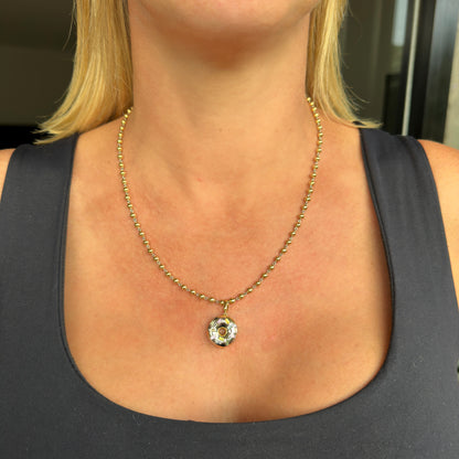 Gold and platinum doughnut pendant charm with no heat natural sapphires by Valentina Fine Jewellery. Global free shipping including UK, USA and Australia. Shown with our gold ball chain necklace.