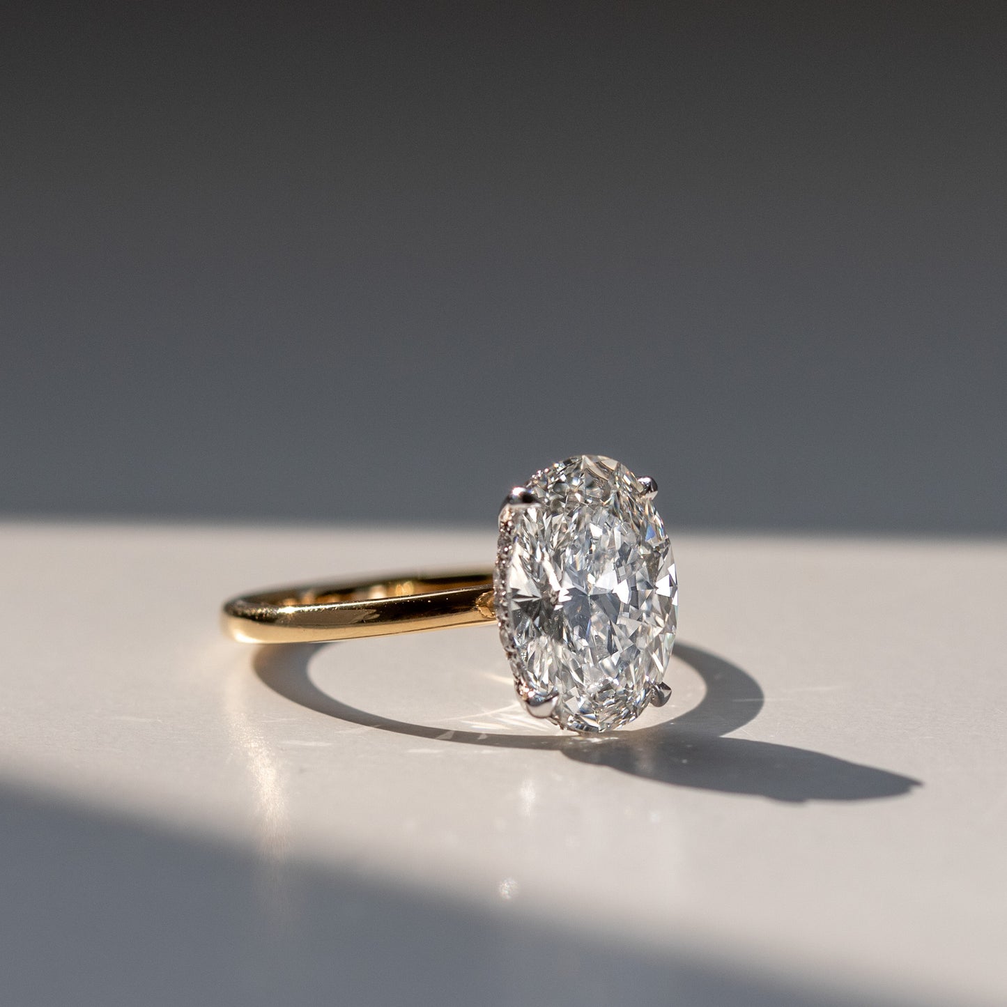 3 carat oval diamond engagement ring with a hidden diamond halo in gold and platinum by Valentina Fine Jewellery HK. Global free shipping including Australia, New Zealand and USA. Lab grown engagement rings are a popular choice in HK for couples who wish to maximise the carat size of their ring.